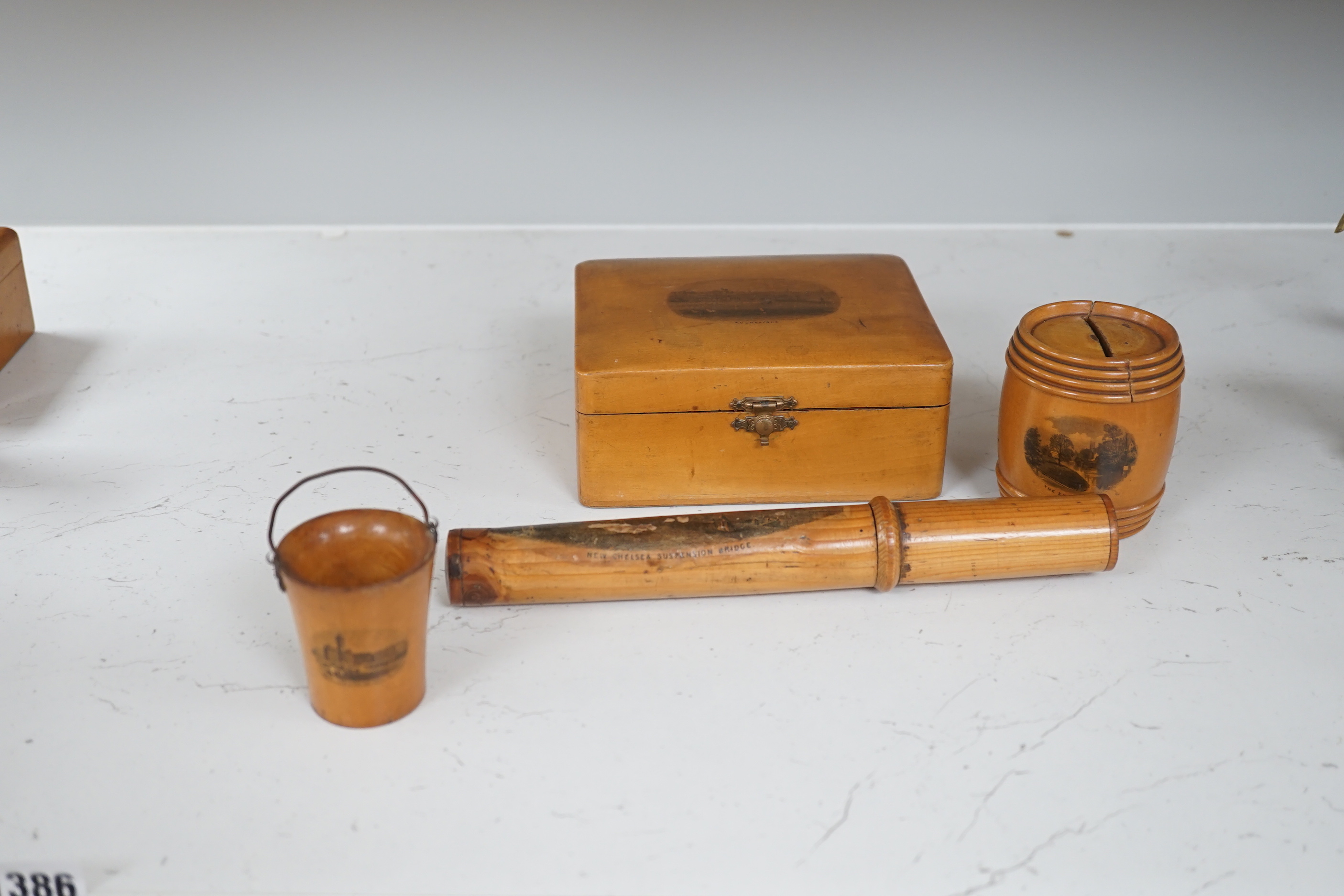 A collection of mixed Mauchline wares, including six egg cups on stand, a house money box, various boxes, letter openers and a Scottish song book, 14cm high (16)